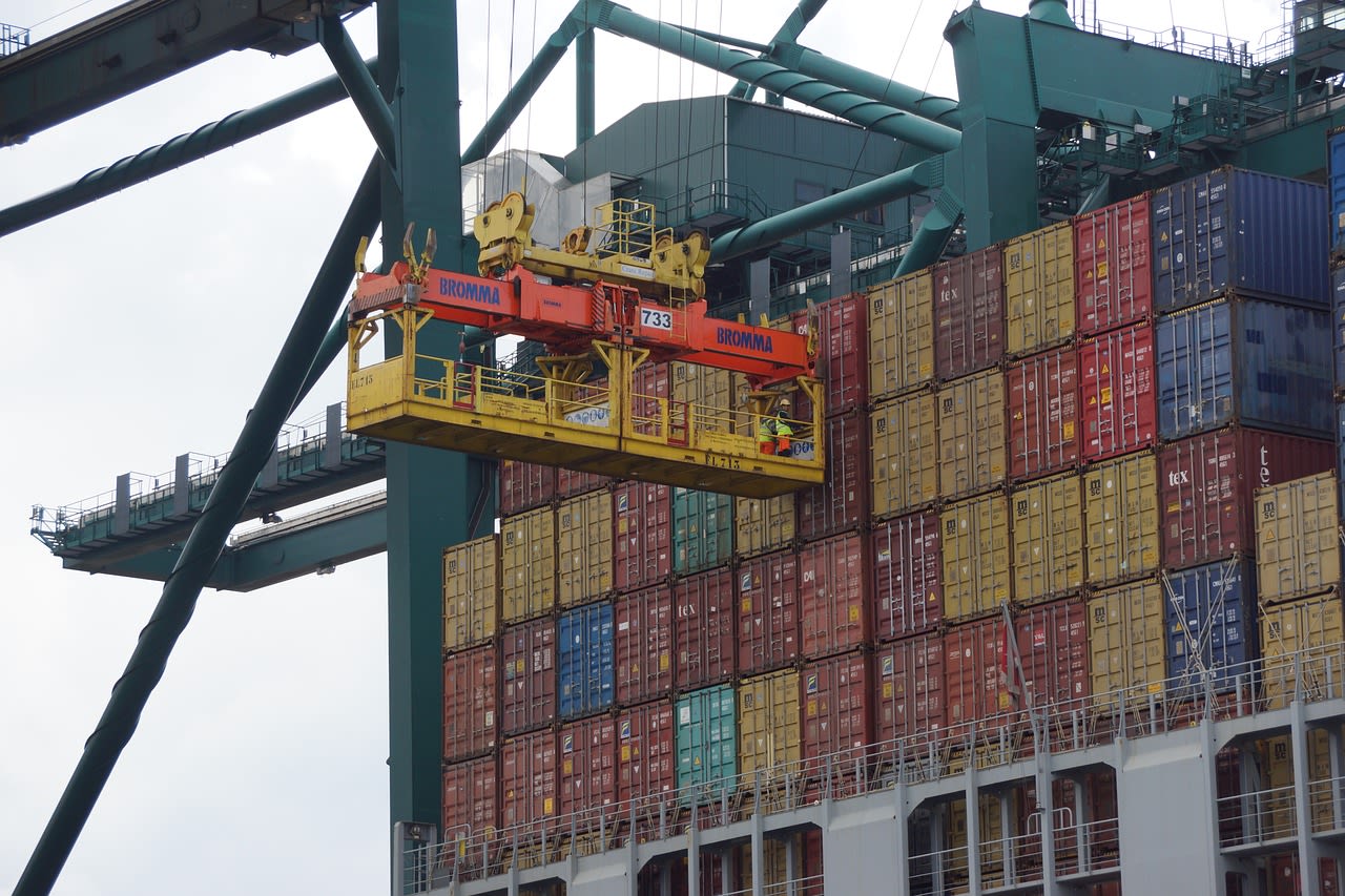 a large amount of containers are stacked on top of each other